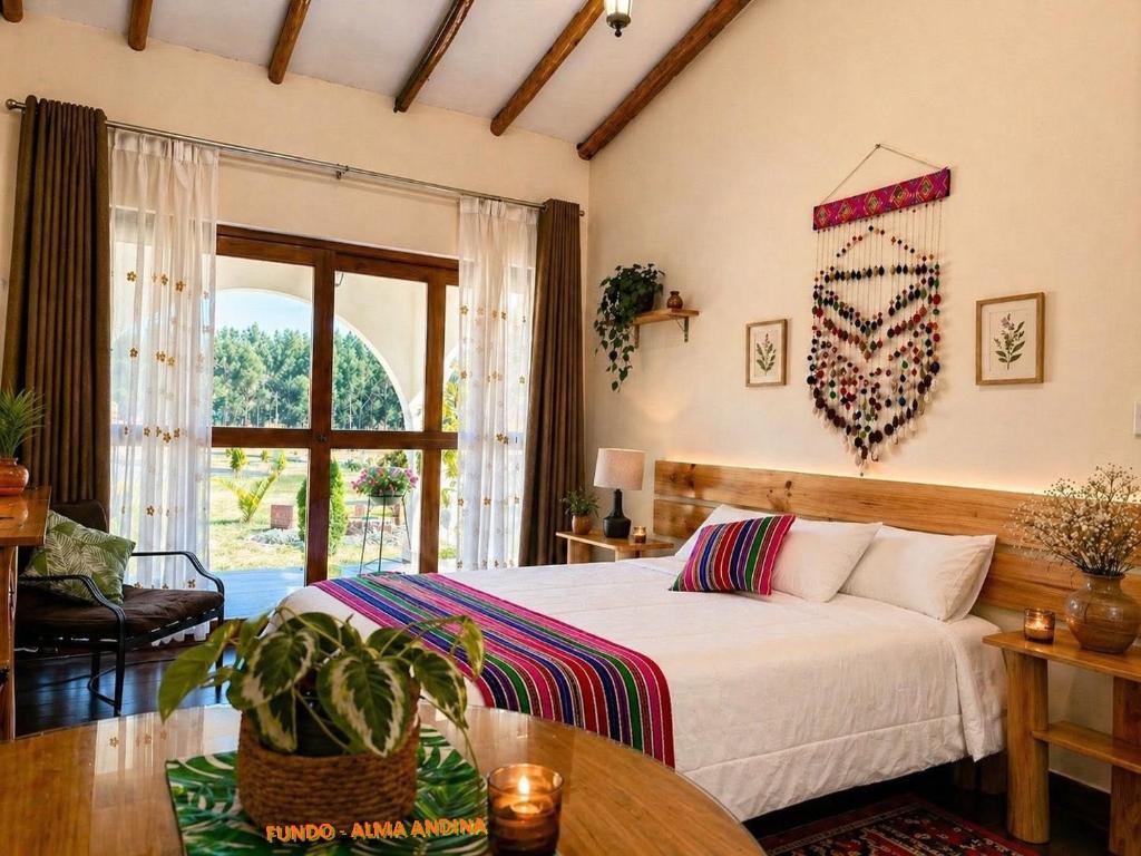 a bedroom with a bed and a table and a window at Fundo Alma Andina in Jauja