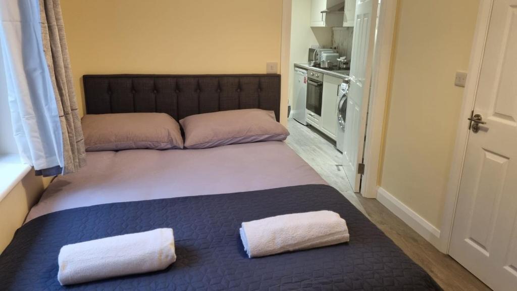a bed with two pillows on it in a room at Cosy Condo near City & Airport in Dublin
