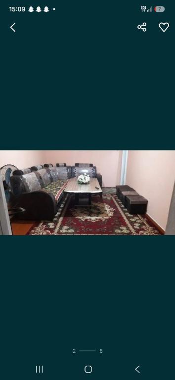 a living room with a couch and a coffee table at 2-kichik daha in Andizhan
