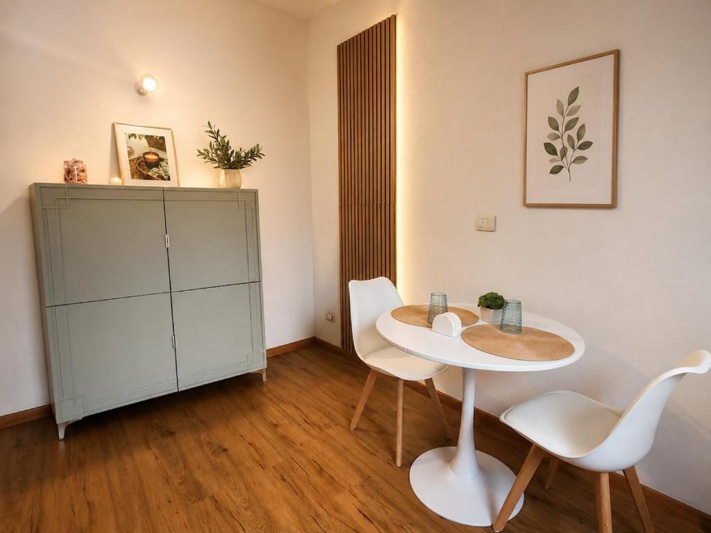 a room with a table and chairs and a cabinet at Casa Camelia Mare in Viareggio