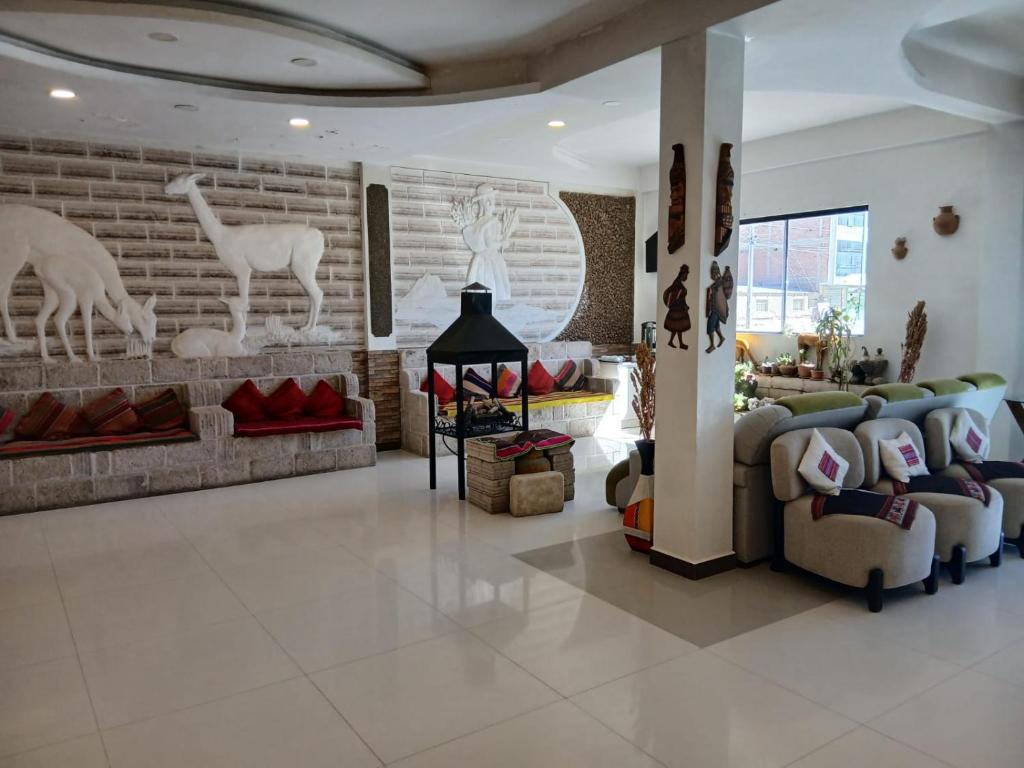 a living room with couches and a brick wall at Hotel Cristales De Sal in Uyuni