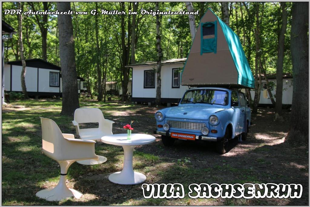 an old blue car with a tent on top of it at KULT TRABANT "Villa Sachsenruh" direkt am Strand in Dranske