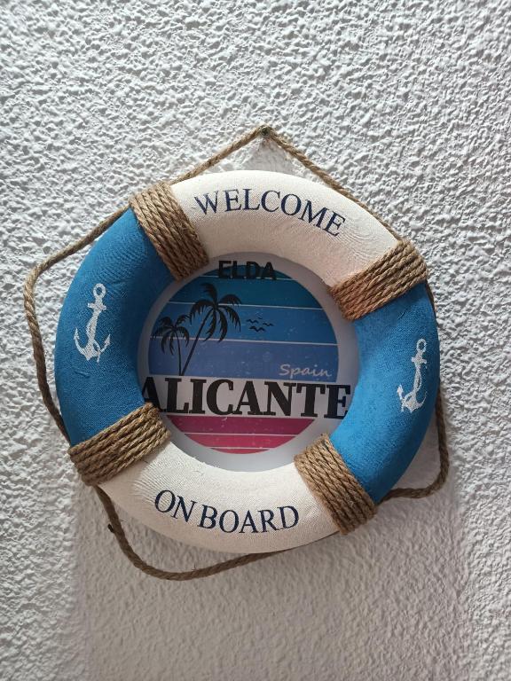 a sign on a wall that reads welcome to an island on board at Apartamento Libertad in Elda