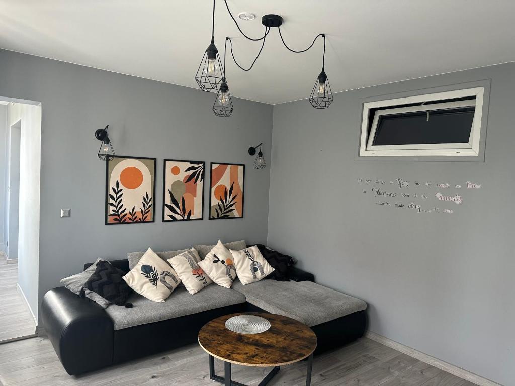 a living room with a couch and a table at Apartament24-Just in Center in Bolesławiec