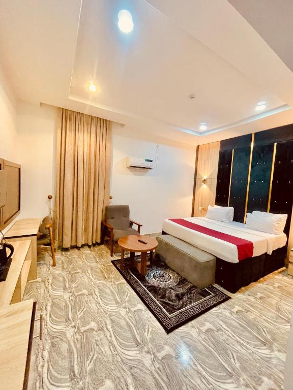 a hotel room with a bed and a television at Lexworld Hotels in Aba