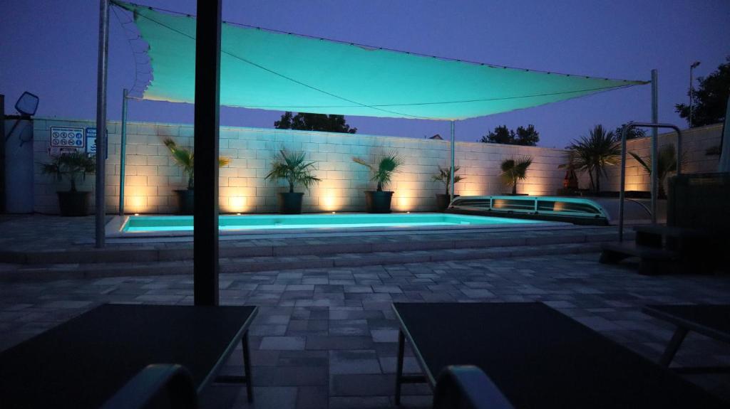 a building with a swimming pool at night at Siófok apartman in Siófok