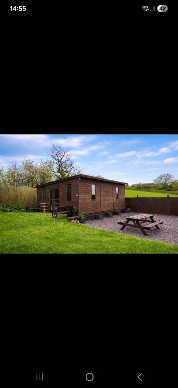 a building with a picnic table in front of it at The Mid Devon Retreat in Crediton