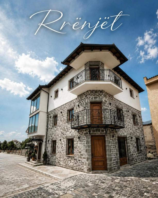 a building with a balcony on top of it at Rrenjet - The Roots in Ersekë