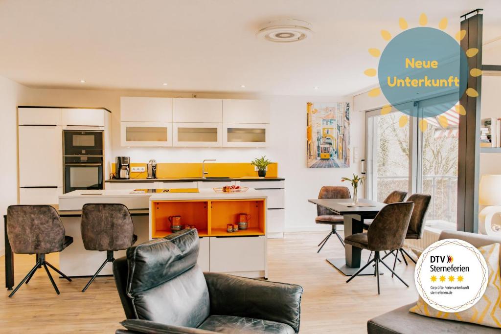 a kitchen and dining room with a table and chairs at Lago Edera - Panoramablick in Hemfurth-Edersee