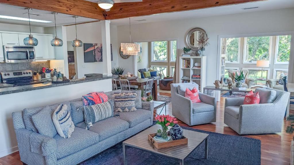 a living room with two couches and a kitchen at 3017 Ocean Winds in Seabrook Island
