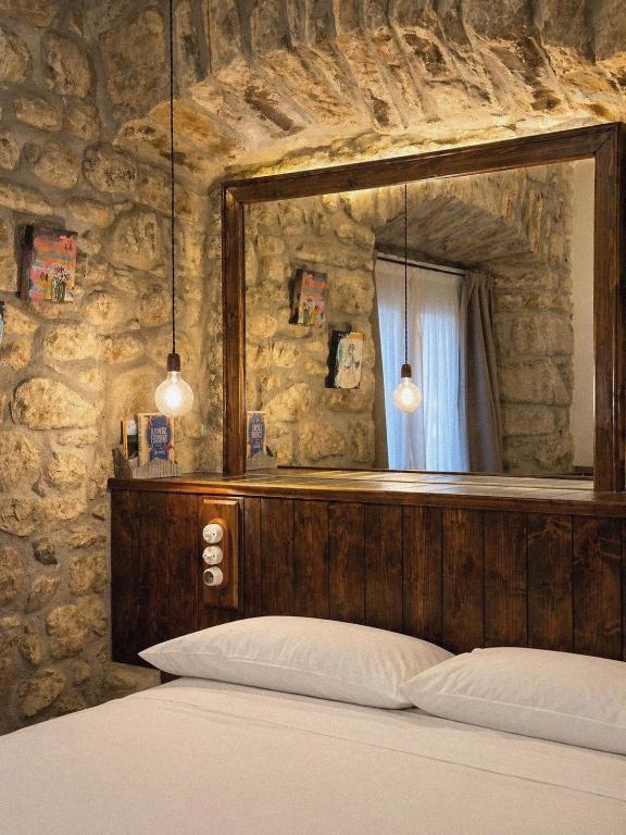 a bedroom with a large mirror above a bed at Apartamentos El Capitan in Potes