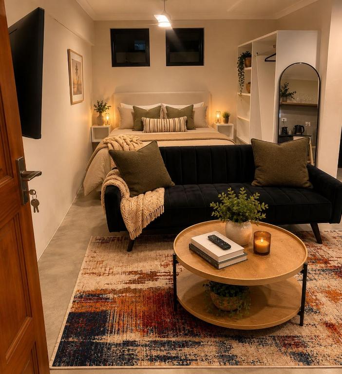 a living room with a couch and a bed at The Cabernet Cottage - One Bedroom in Table View