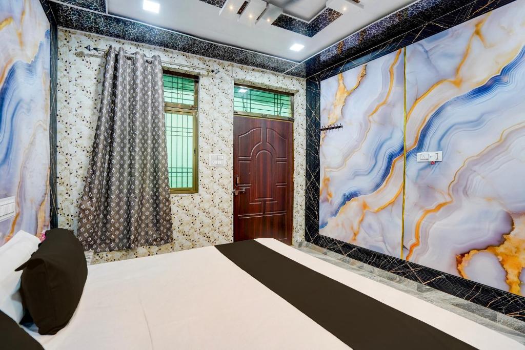 a bedroom with a bed and a door at Hotel O Royal Prayag in Prayagraj