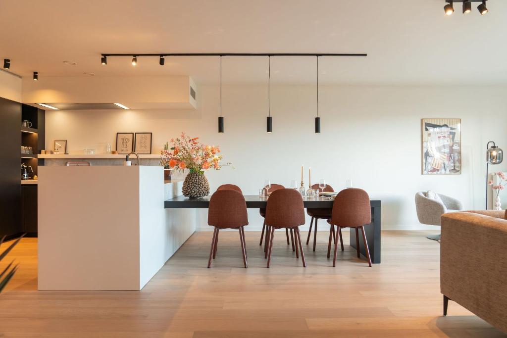 a kitchen and dining room with a table and chairs at The Strand Agency - June in Cadzand-Bad