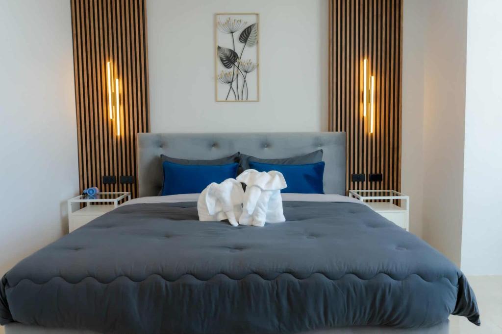 a bedroom with a large bed with two towels on it at PGD Blue city view in Rawai Beach