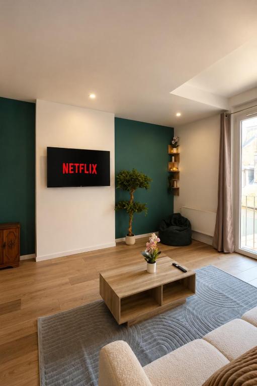 a living room with ametix sign on the wall at Terre d'Oasis - HyperCentre in Besançon
