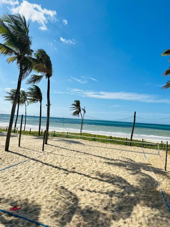 a group of palm trees on a sandy beach at WaiWai Residence Cumbuco in Caucaia