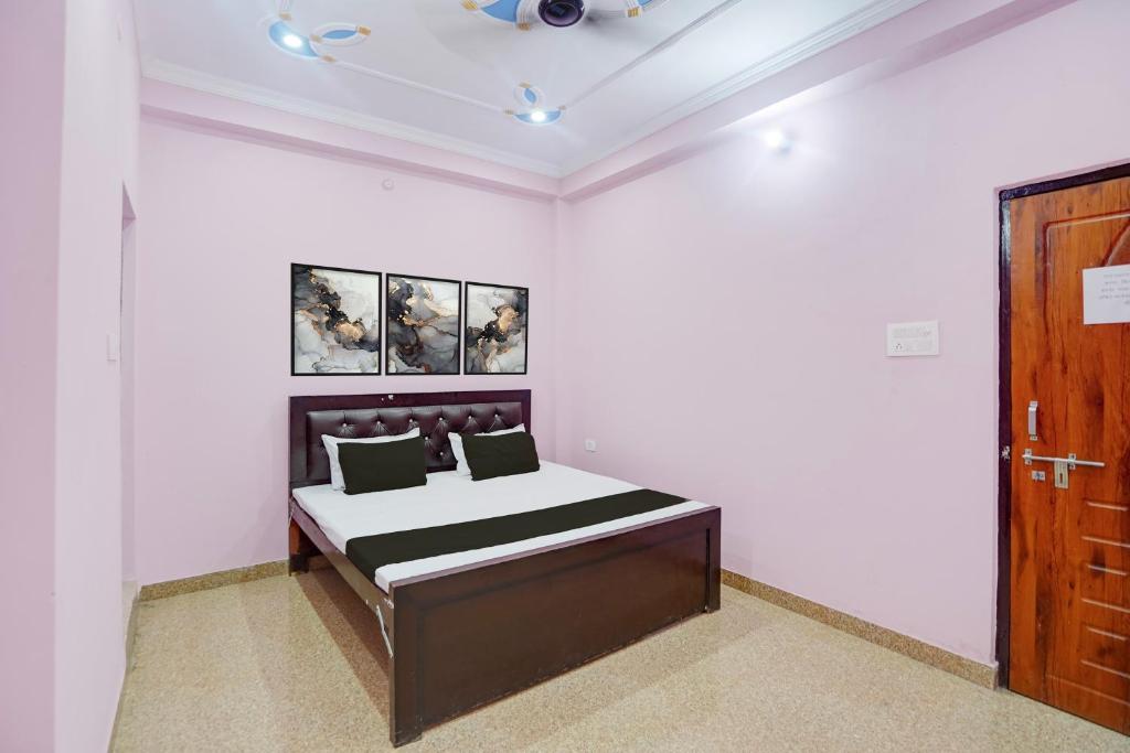 a bedroom with a bed and a wooden door at Hotel O Relax Inn in Lucknow