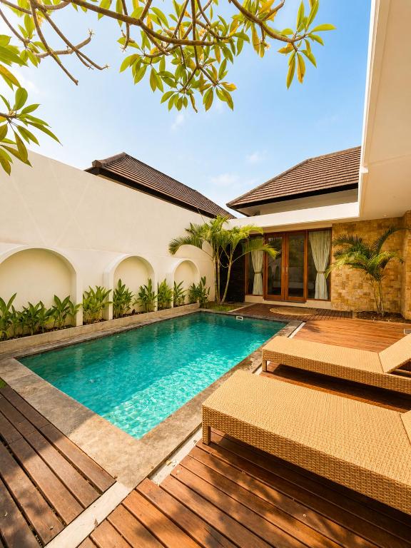 a swimming pool in the backyard of a house at Asania Villa in Uluwatu
