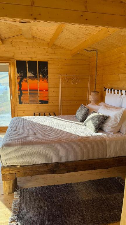a bedroom with a large bed in a wooden room at Love Nest by taste of Antiparos in Antiparos