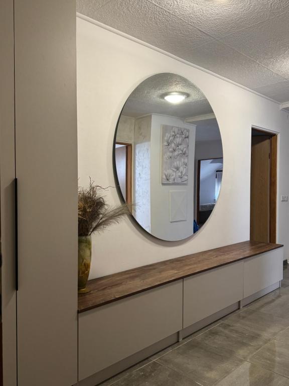 a mirror on a wall in a hallway at Apartment Luvera in Ludbreg