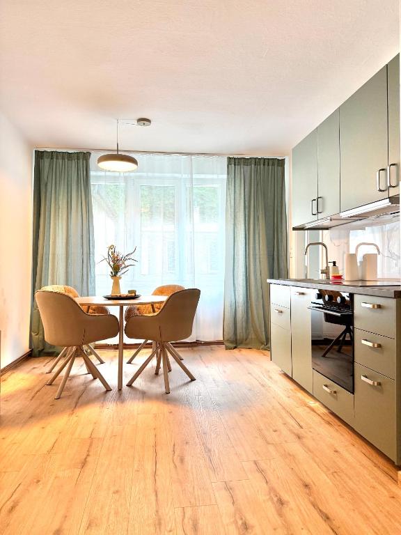 a kitchen with a table and chairs in a room at Mountain Nest Apartment in Schottwien