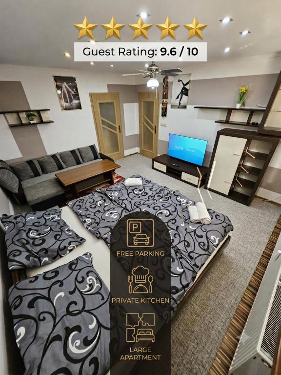 a room with a bed and a living room at APARTMAN WOLF Luxusné priestranné ubytovanie s Výhľadom na hory s Bezplatným Parkovaním Veľkou SMART TV Rýchlym Optickým Internetom Priamo v PB Tichá lokalita Všetko na blízku Vhodné pre Rodinu Skupinu Pracovné cesty aj Turistiku Plne vybavená Kuchyňa in Považská Bystrica