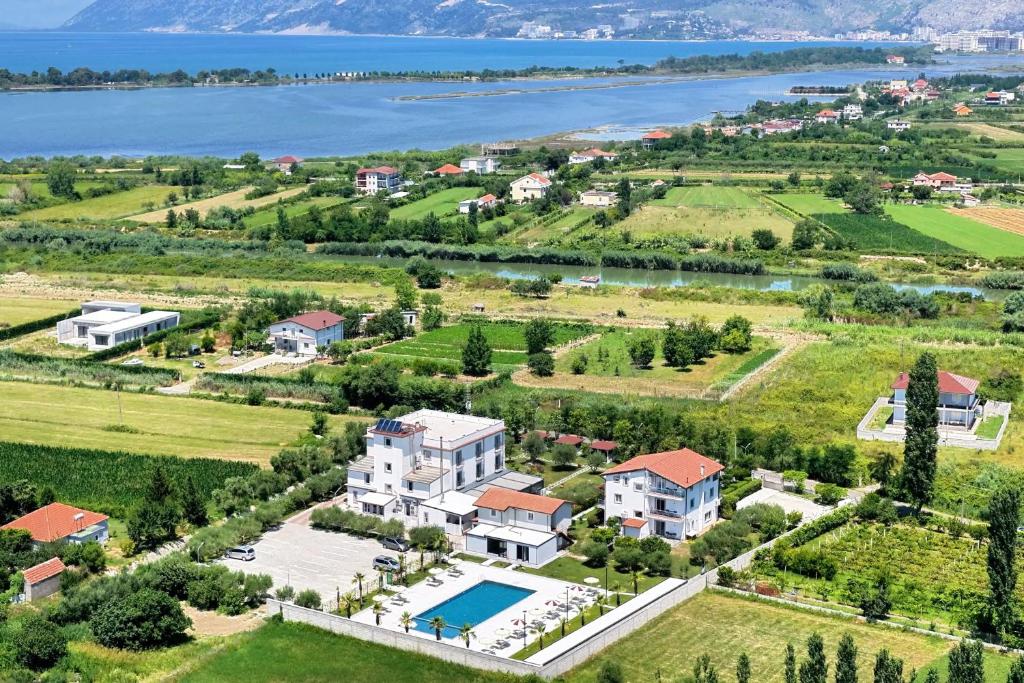 an aerial view of a large estate with a lake at Evergreen Laguna Vain-Lezhe in Lezhë