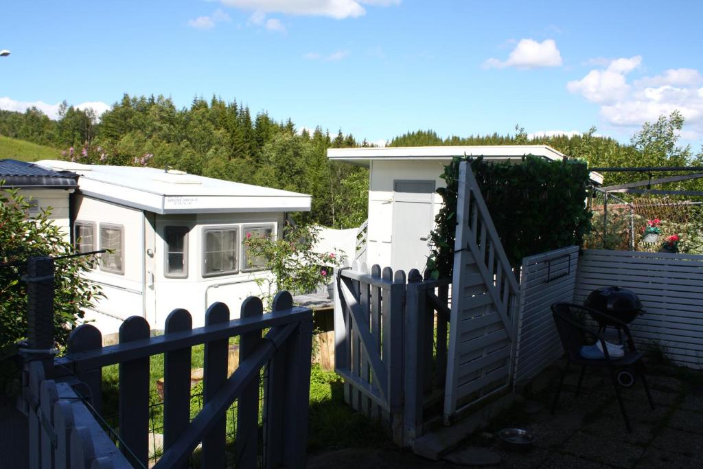 a white house with a gate and a fence at Visit Senja Lady in Senja
