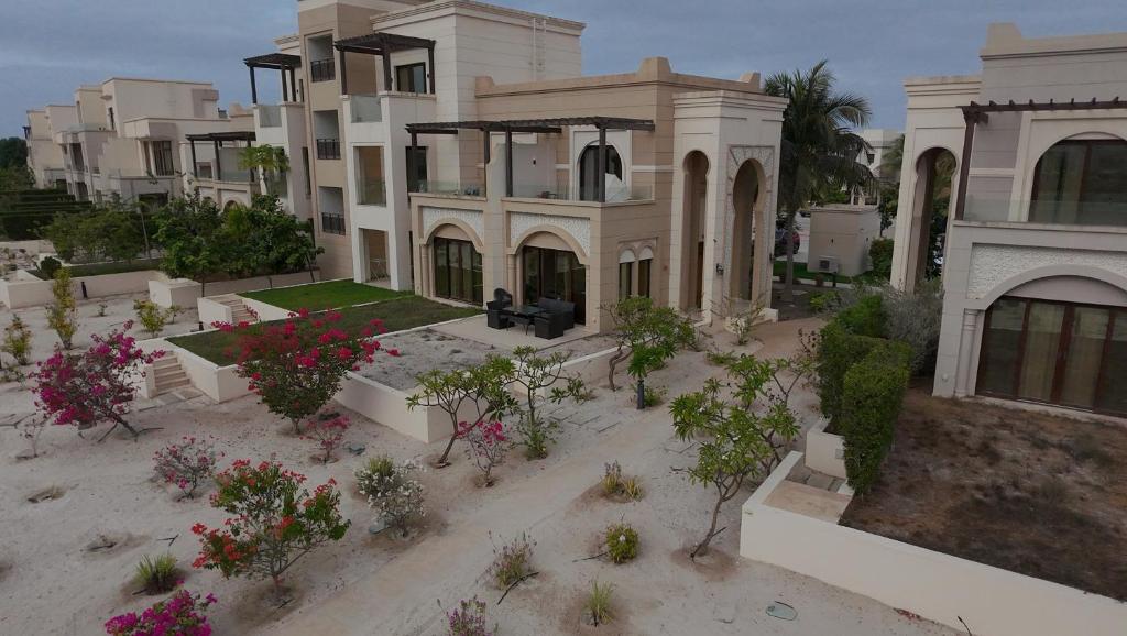 a large house with flowers in front of it at Zill Hawana in Ma‘mūrah
