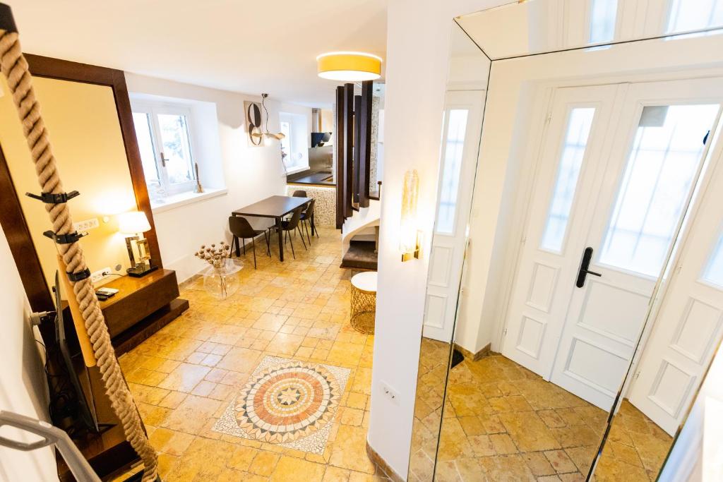 a hallway with a door and a living room at Casa Matteo Piran in Piran