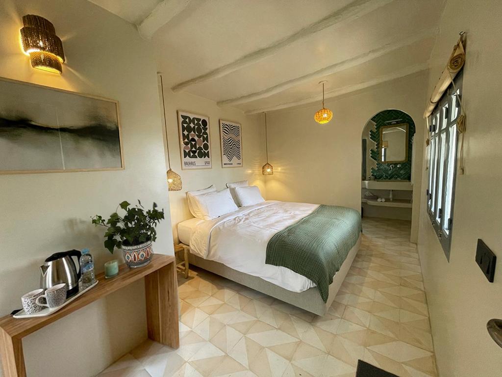a bedroom with a large bed in a room at Dar Serenia Rohuna in Rehouna