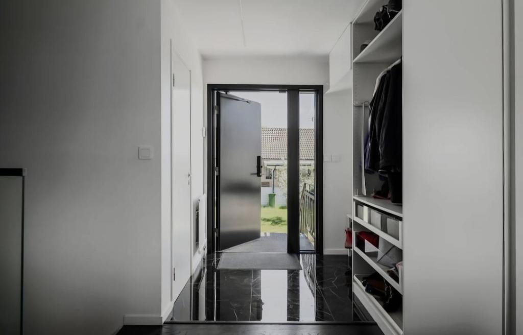 a hallway with a door leading into a room at Scandinavian Villa in Ösmo