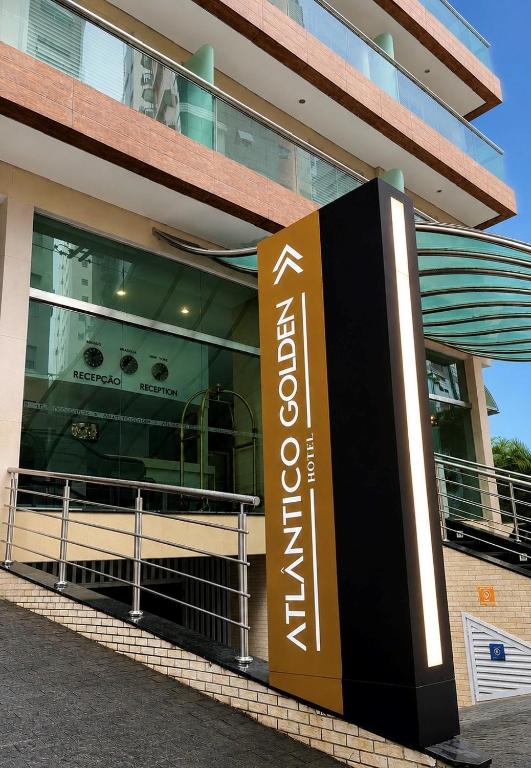 a building with a sign in front of it at Atlântico Golden Apart Hotel in Santos
