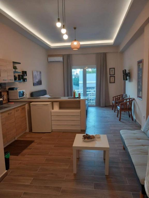 a kitchen and living room with a couch and a table at Modern flat in town center! in Kiaton