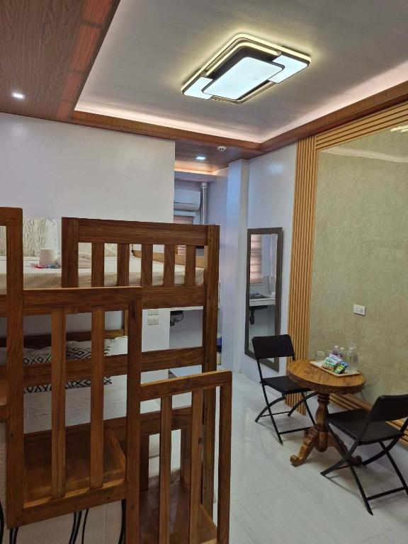 a room with two bunk beds and a table at Silid in Legazpi