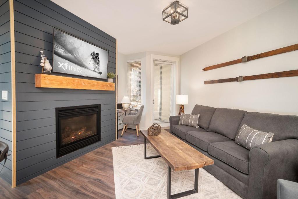 a living room with a couch and a fireplace at Fraser Crossing 3309 in Winter Park