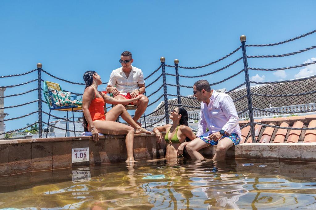 a group of people sitting in the water at Hotel Monaguillo de Getsemaní in Cartagena de Indias