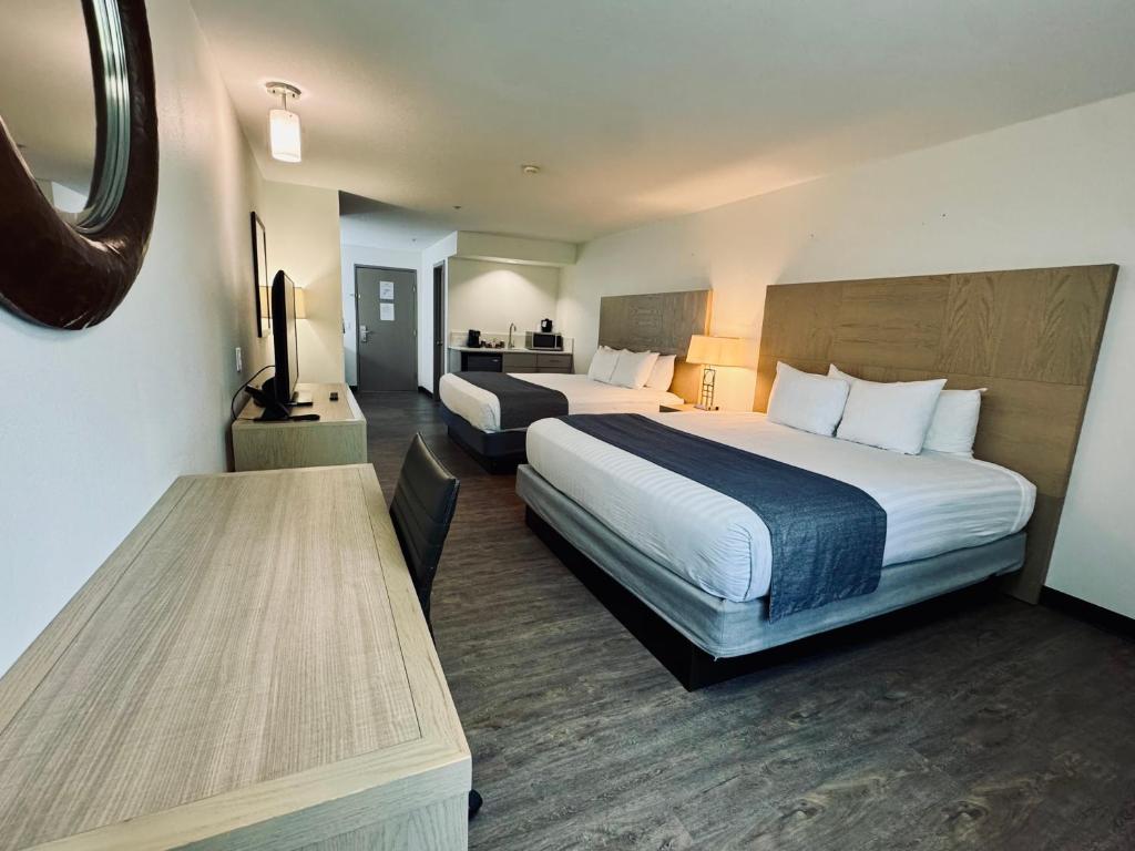 a hotel room with two beds and a table at The Tillamook Inn in Tillamook