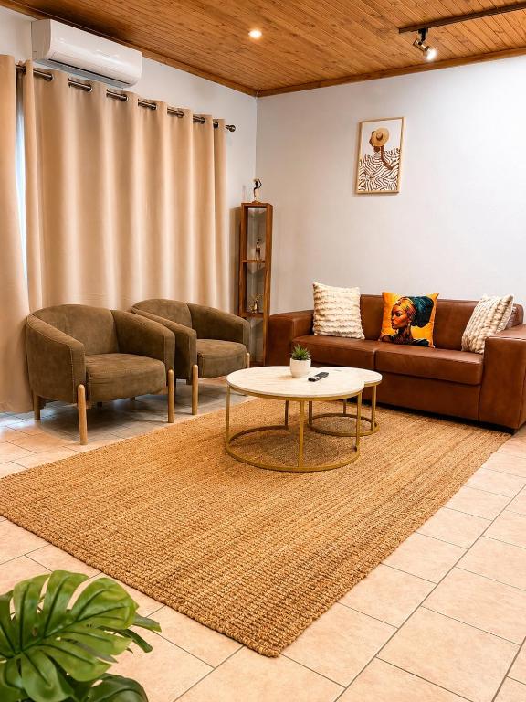 a living room with a couch and a table at CAVE Properties Group in Pionierspark