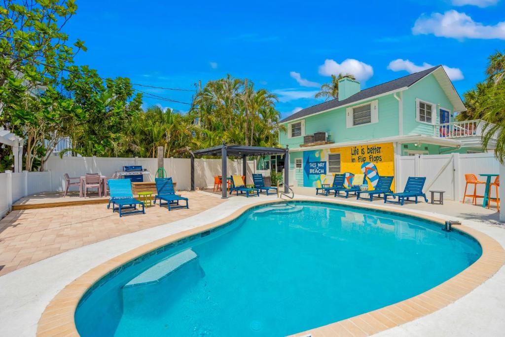 a swimming pool with chairs and a house at Everglades Villa - Sleeps 8 - Walk to Siesta Beach in Siesta Key