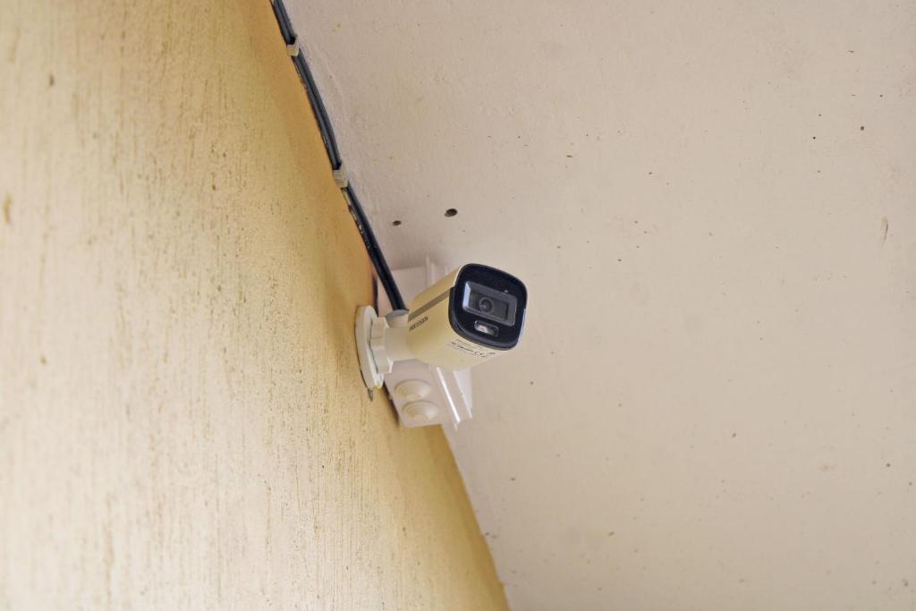 a cell phone on a wire attached to a wall at Kolstar Hotel SMC Ltd in Ogwam