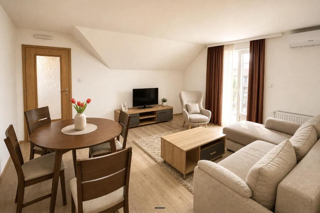 a living room with a couch and a table at Apartmani Resimic in Ivanjica