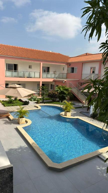 a large swimming pool in front of a building at Residencial Ru-B in Luanda