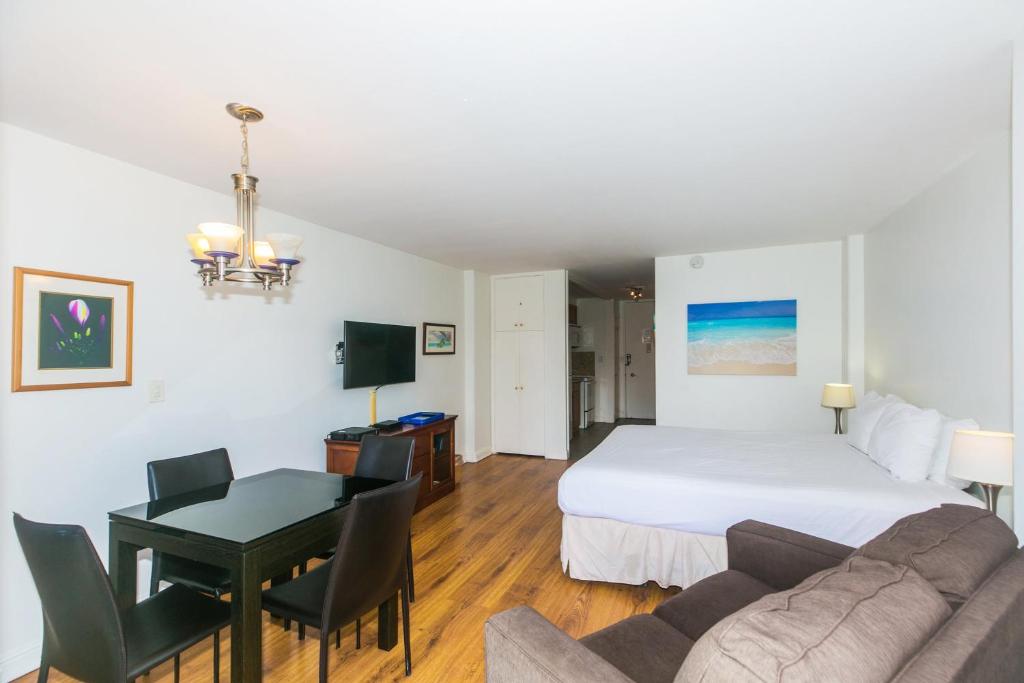 a hotel room with a bed and a desk and a room at Ilikai Marina 1383 in Honolulu