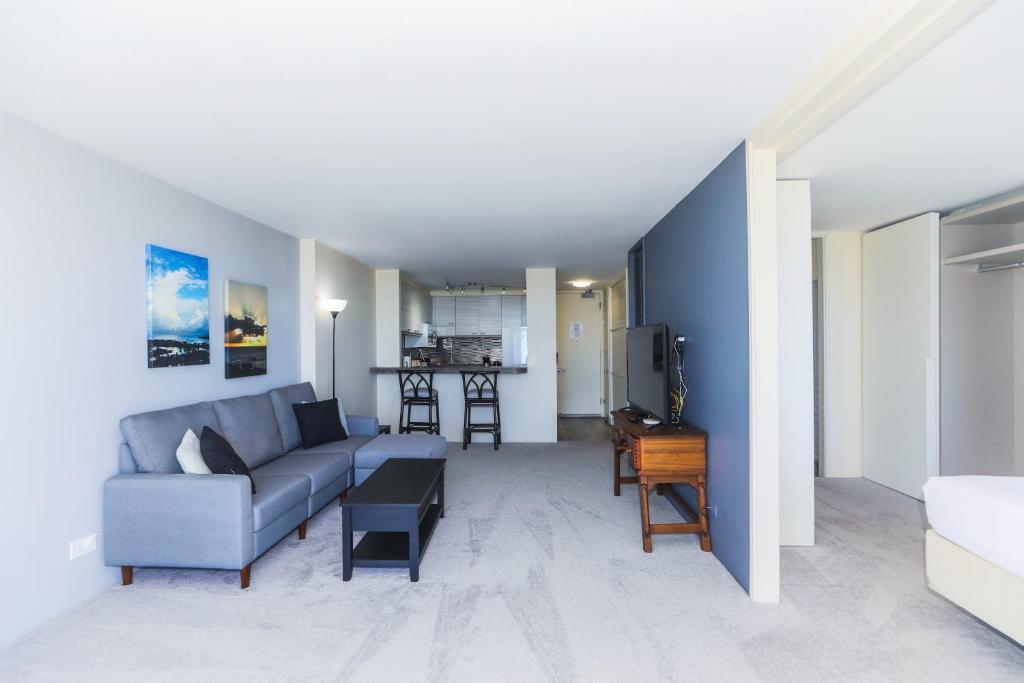 a living room with a couch and a table at Ilikai Marina 1386 in Honolulu