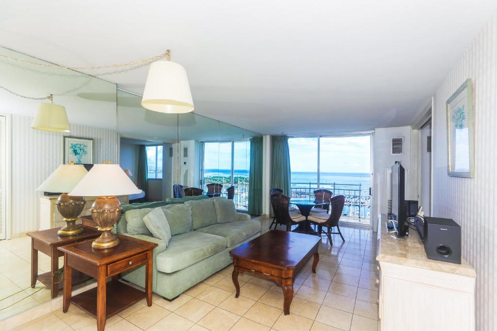 a living room with a couch and a table at Ilikai Marina 1584 in Honolulu