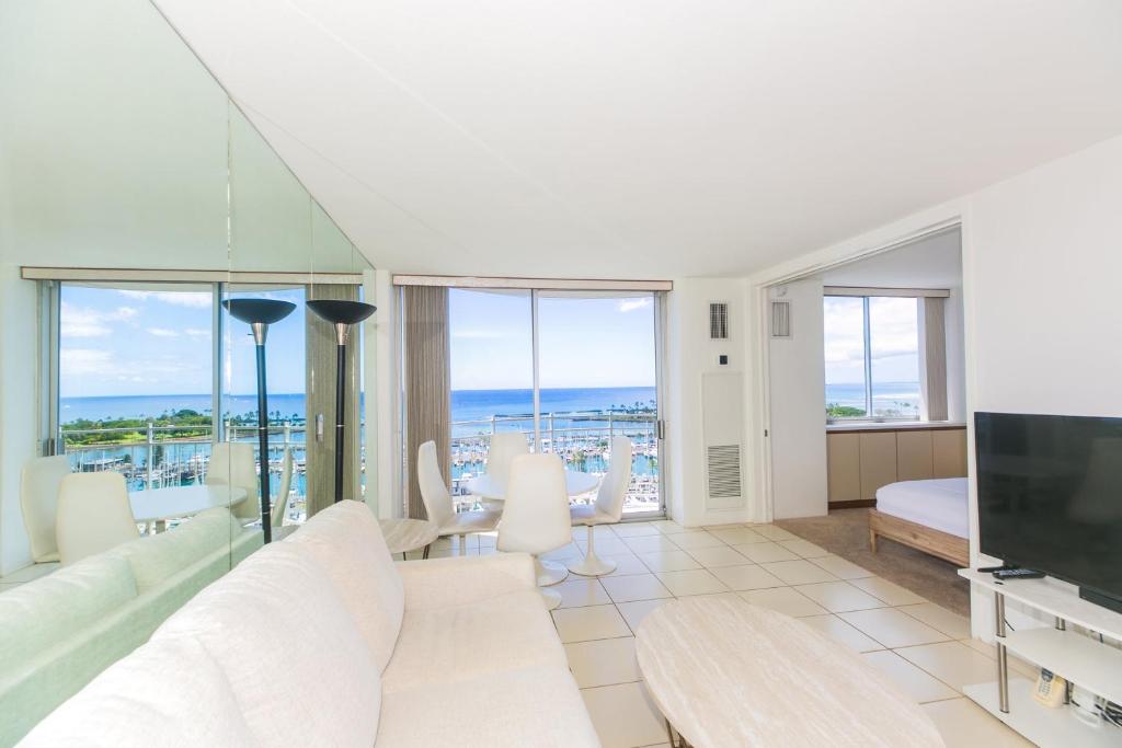 a living room with a couch and a tv at Ilikai Marina 1688 in Honolulu