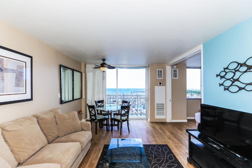 a living room with a couch and a table at Ilikai Marina 984 in Honolulu