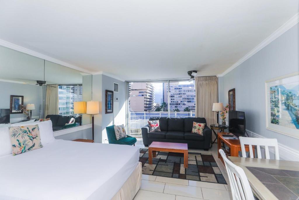 a bedroom with a bed and a living room at Ilikai Marina 987 in Honolulu